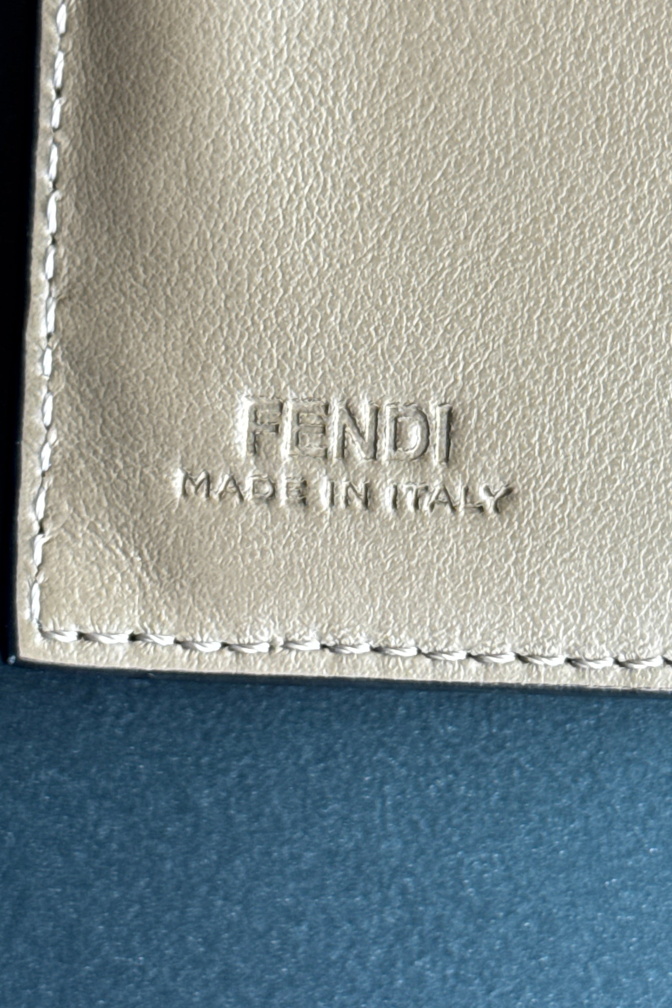 Top view of the authentic Fendi beige leather continental wallet showcasing the spacious interior logo