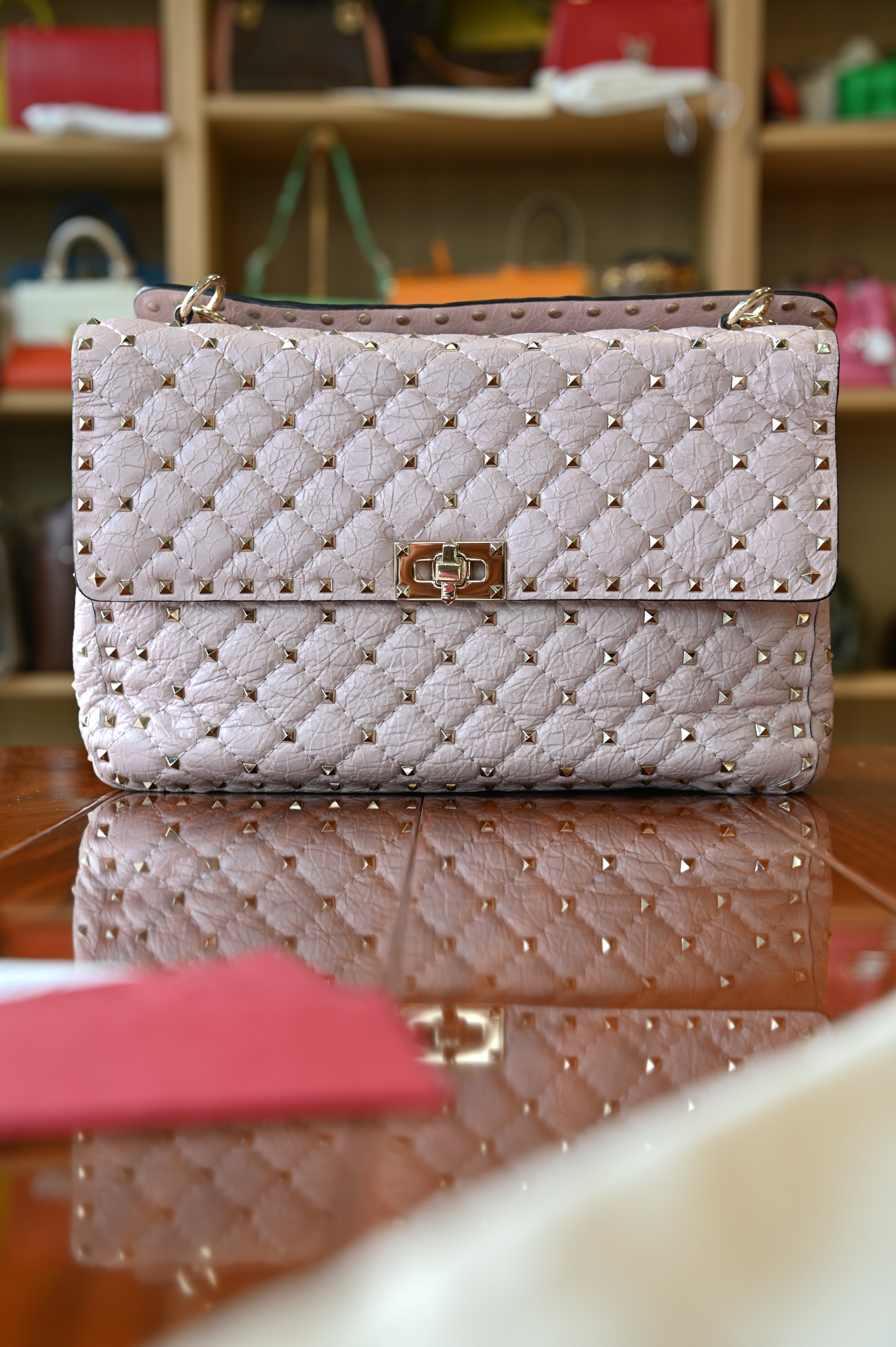 Preloved Valentino Garavani Pink Rockstud Shoulder Bag in blush pink leather featuring signature gold-tone Rockstud embellishments, structured silhouette, adjustable shoulder strap, and elegant luxury design