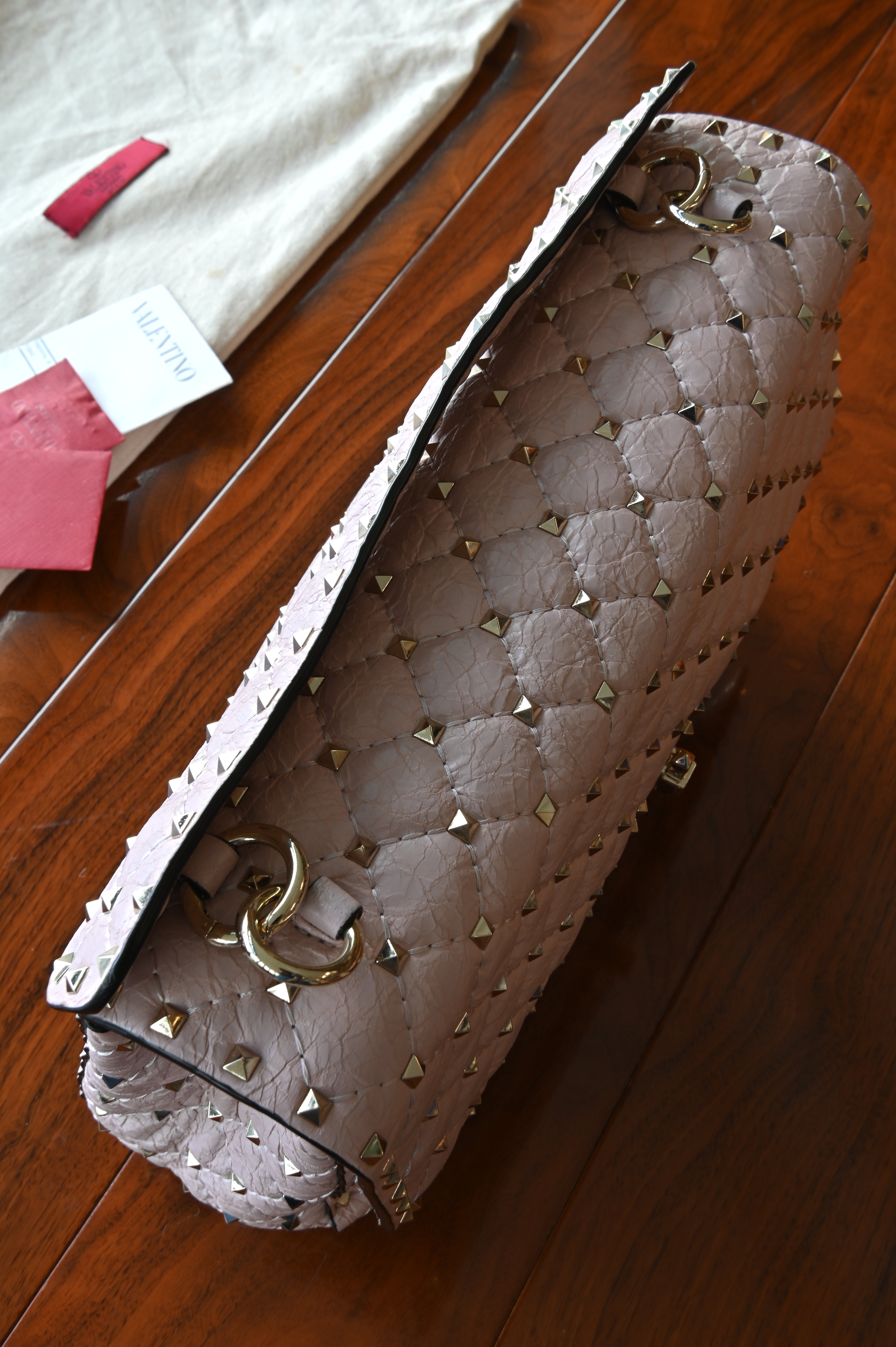 Preloved Valentino Garavani Pink Rockstud Shoulder Bag in blush pink leather featuring signature gold-tone Rockstud embellishments, structured silhouette, adjustable shoulder strap, and elegant luxury design