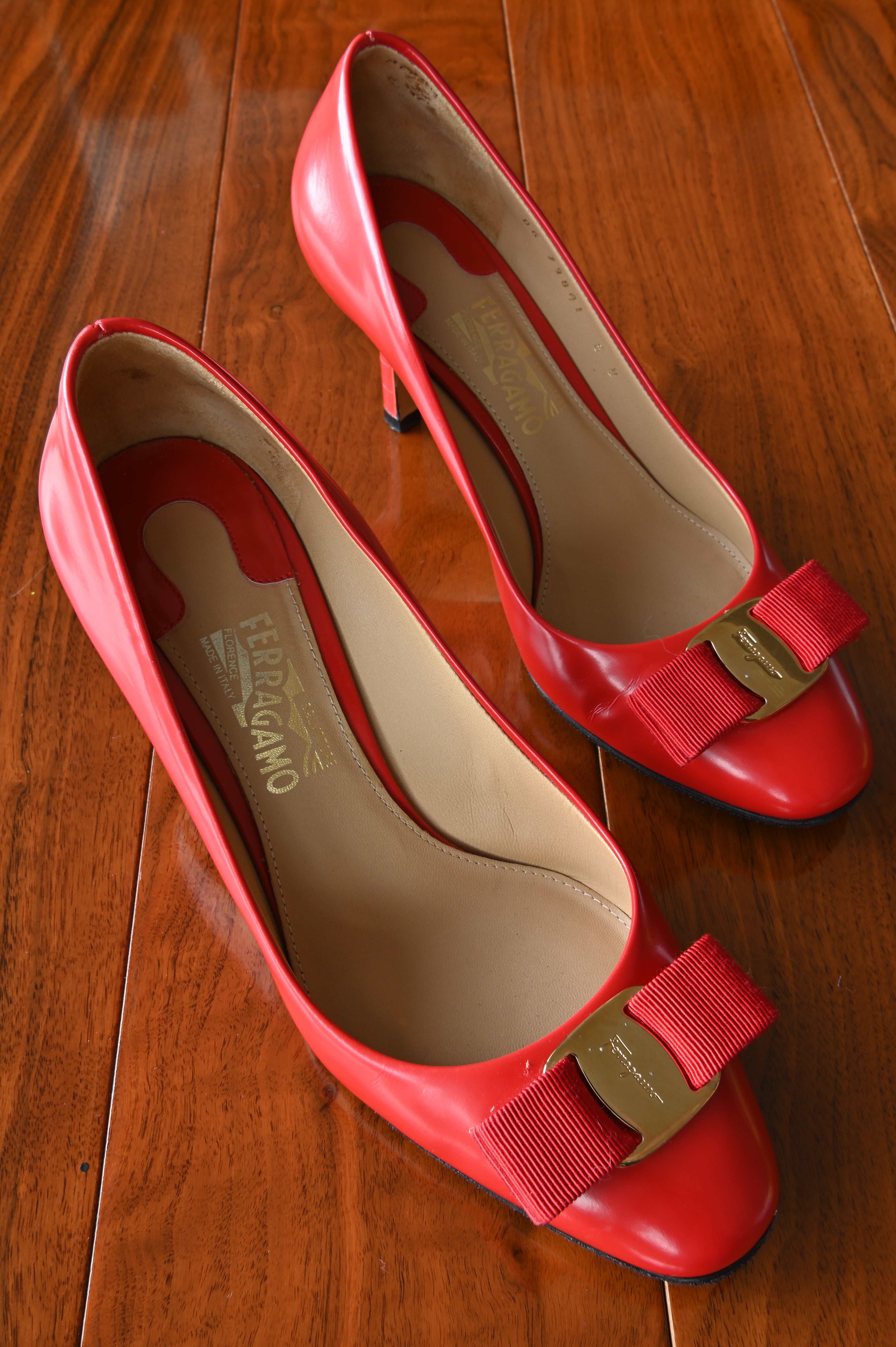 Authentic Salvatore Ferragamo Vara red leather pumps featuring the signature grosgrain bow and gold-tone Vara logo hardware.