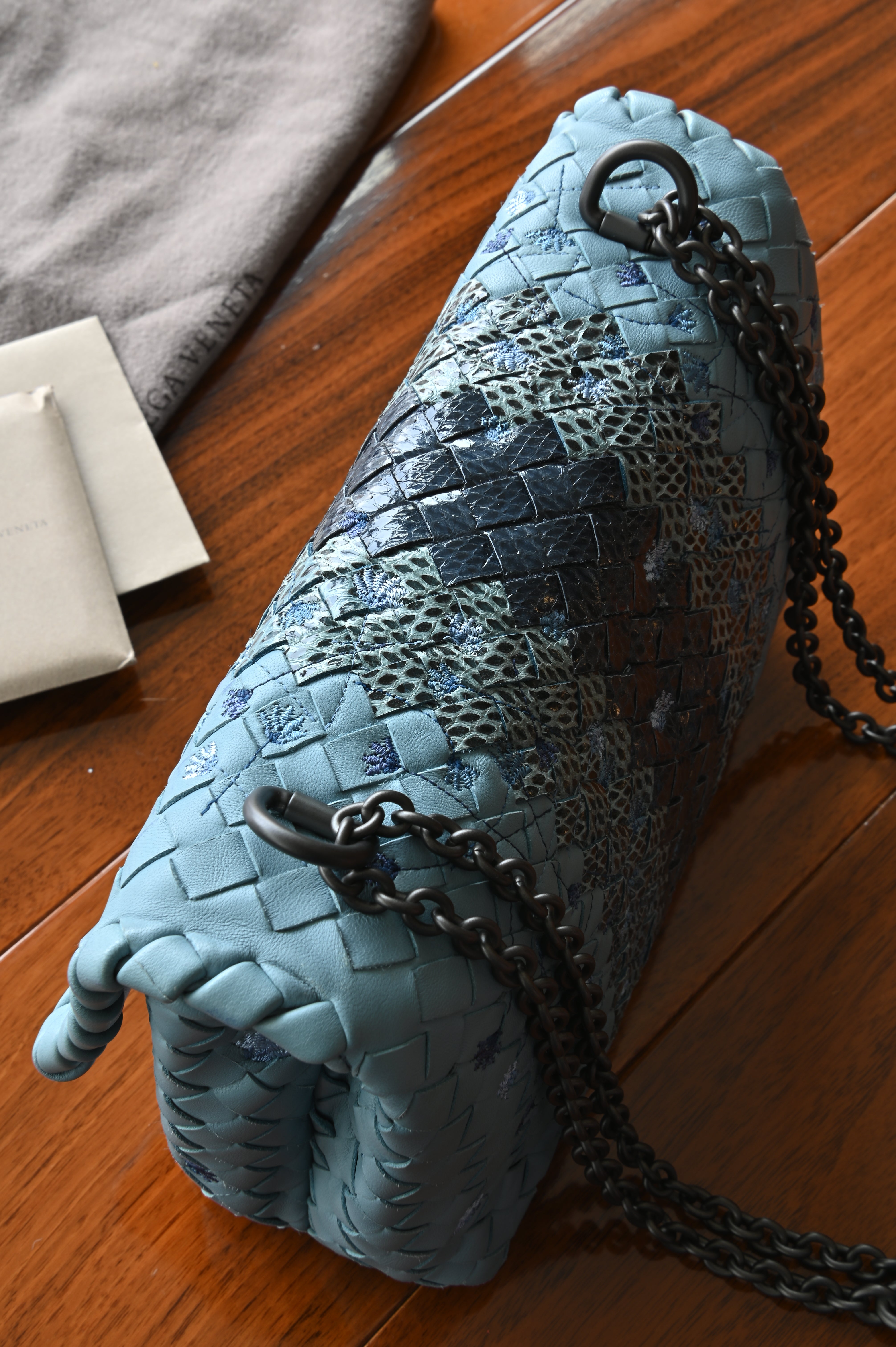 Authentic Bottega Veneta Blue Intrecciato Woven Crossbody Bag showing the structured leather base with woven python leather detailing.