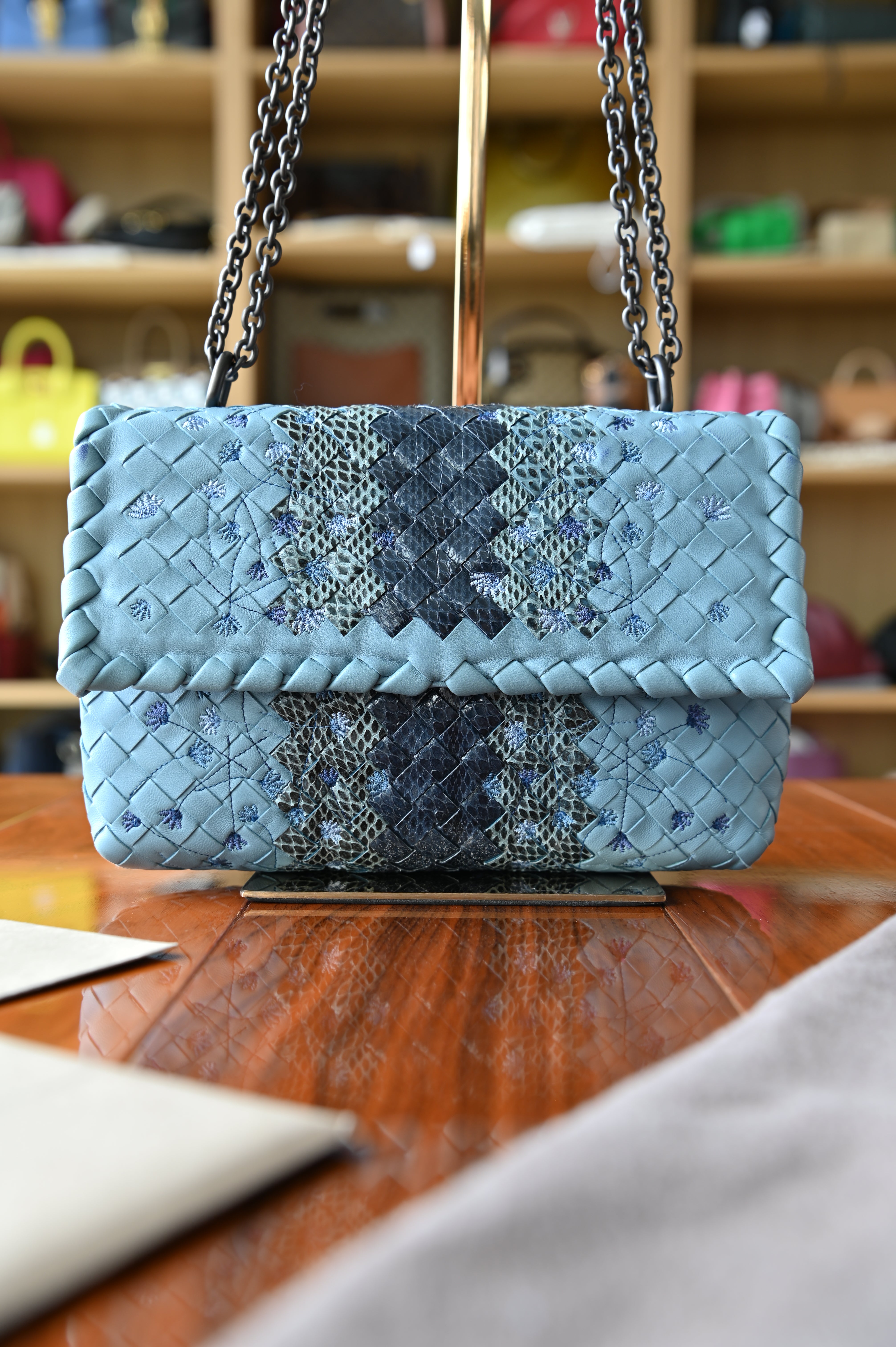 Authentic Bottega Veneta Blue Intrecciato Woven Crossbody Bag featuring genuine python leather woven into the iconic Intrecciato design, front view with chain shoulder strap.