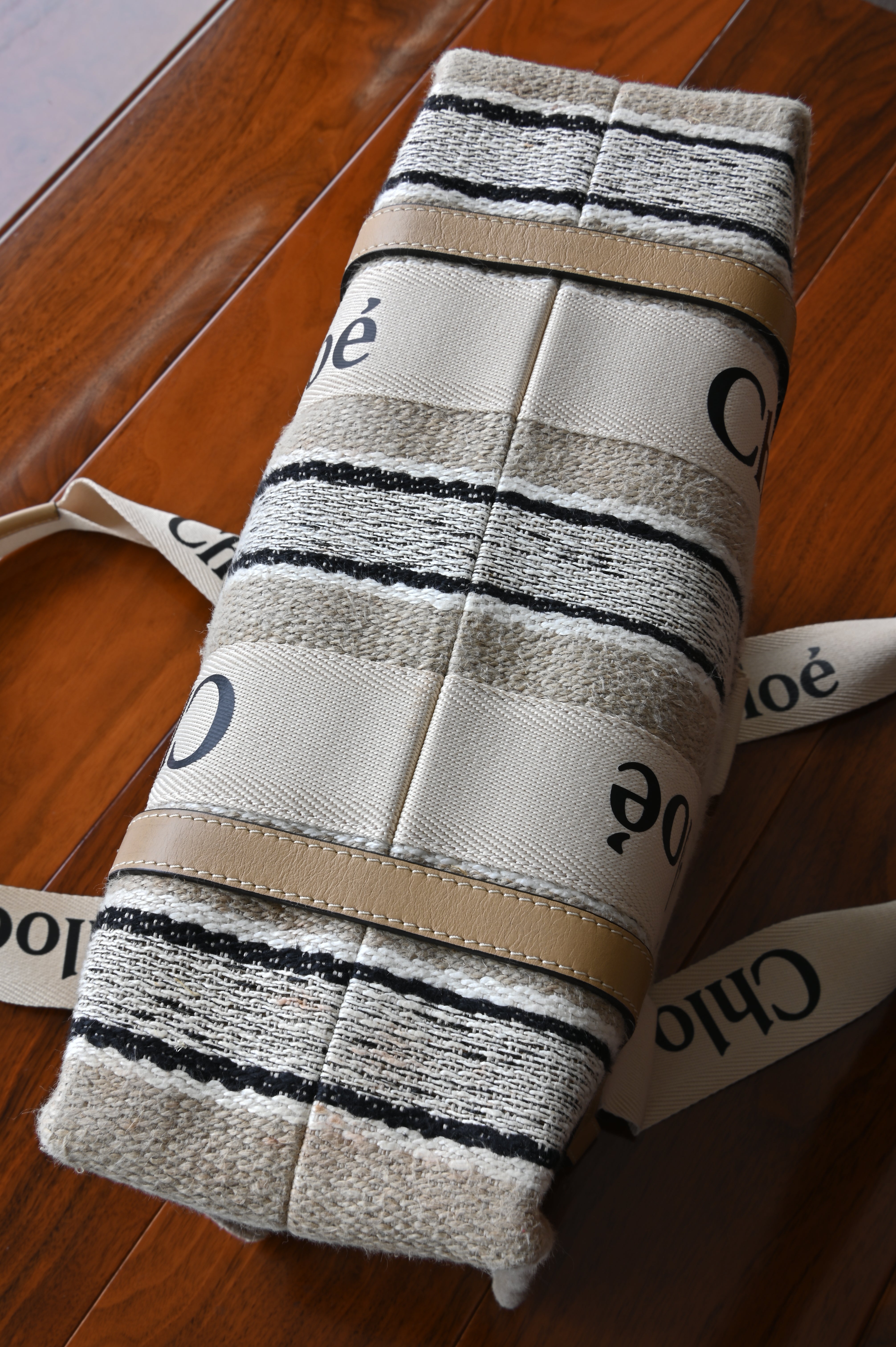 Authentic Chloé Woody Medium Striped Tote Bag showing the structured canvas base with striped design and durable construction.