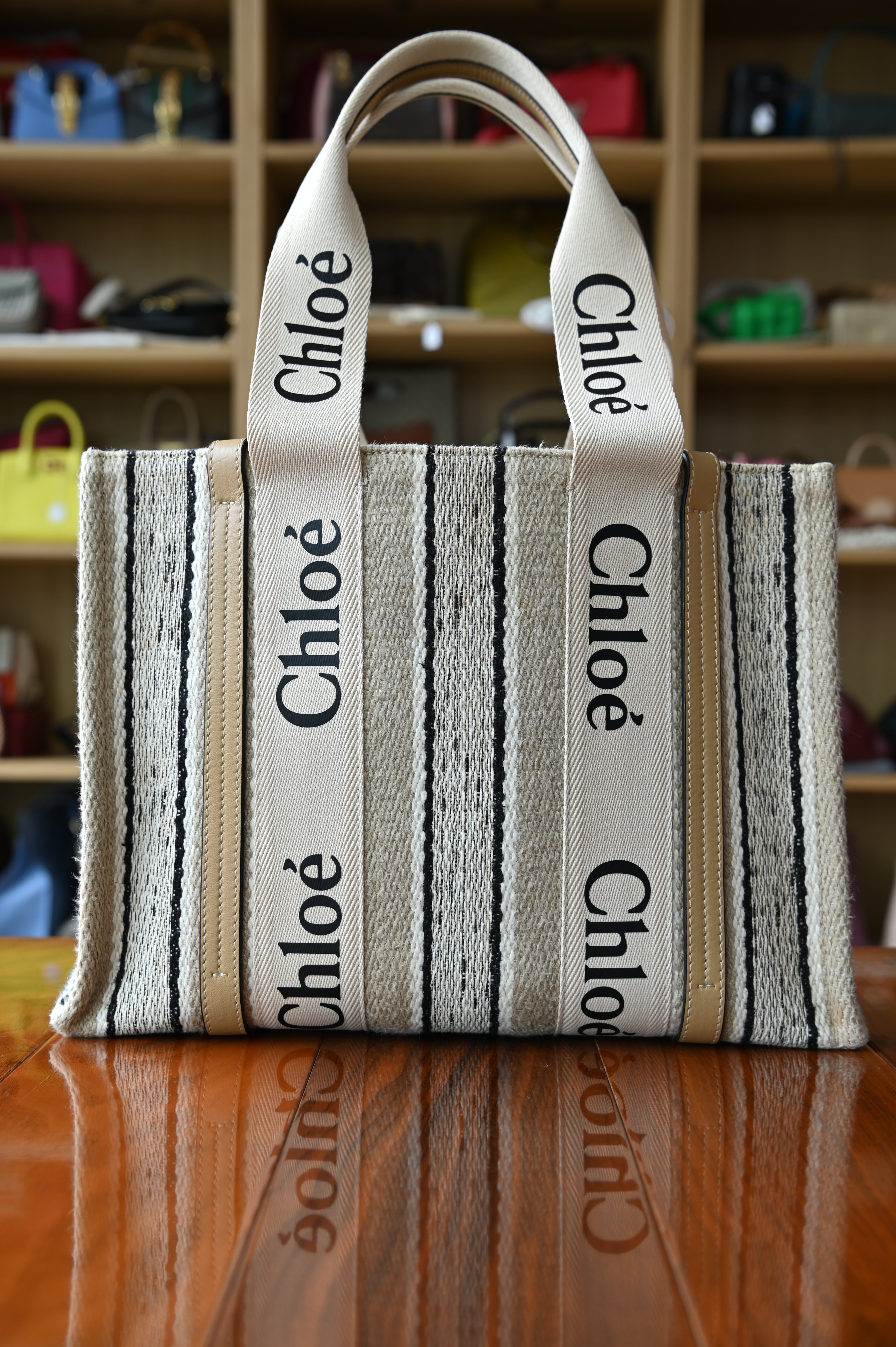 Authentic Chloé Woody Medium Striped Tote Bag in beige canvas featuring signature logo webbing handles and spacious tote silhouette, front view.