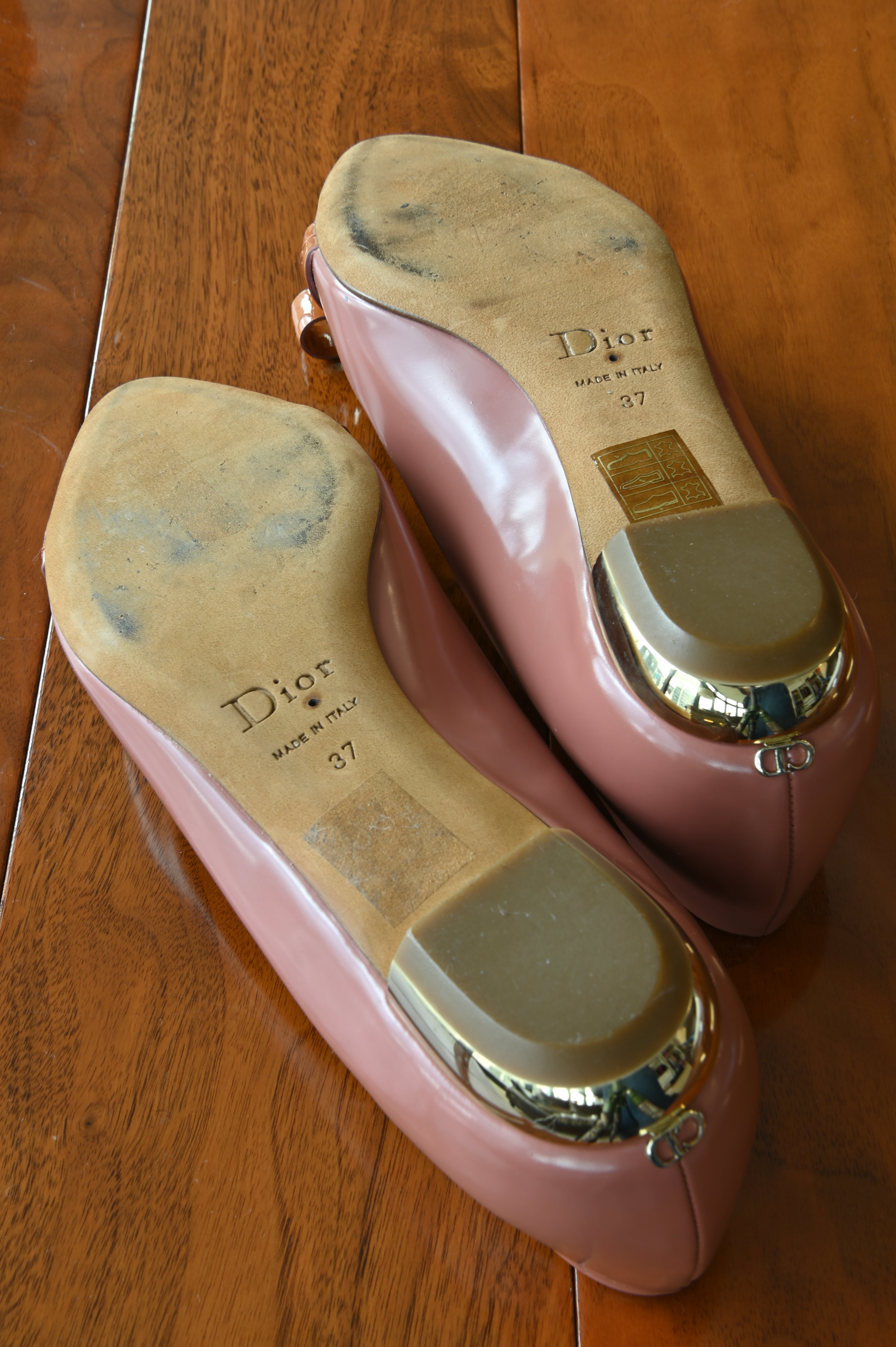 Authentic Christian Dior Dusty Rose Patent Ballet Flats showing the outsoles with signs of careful previous wear.