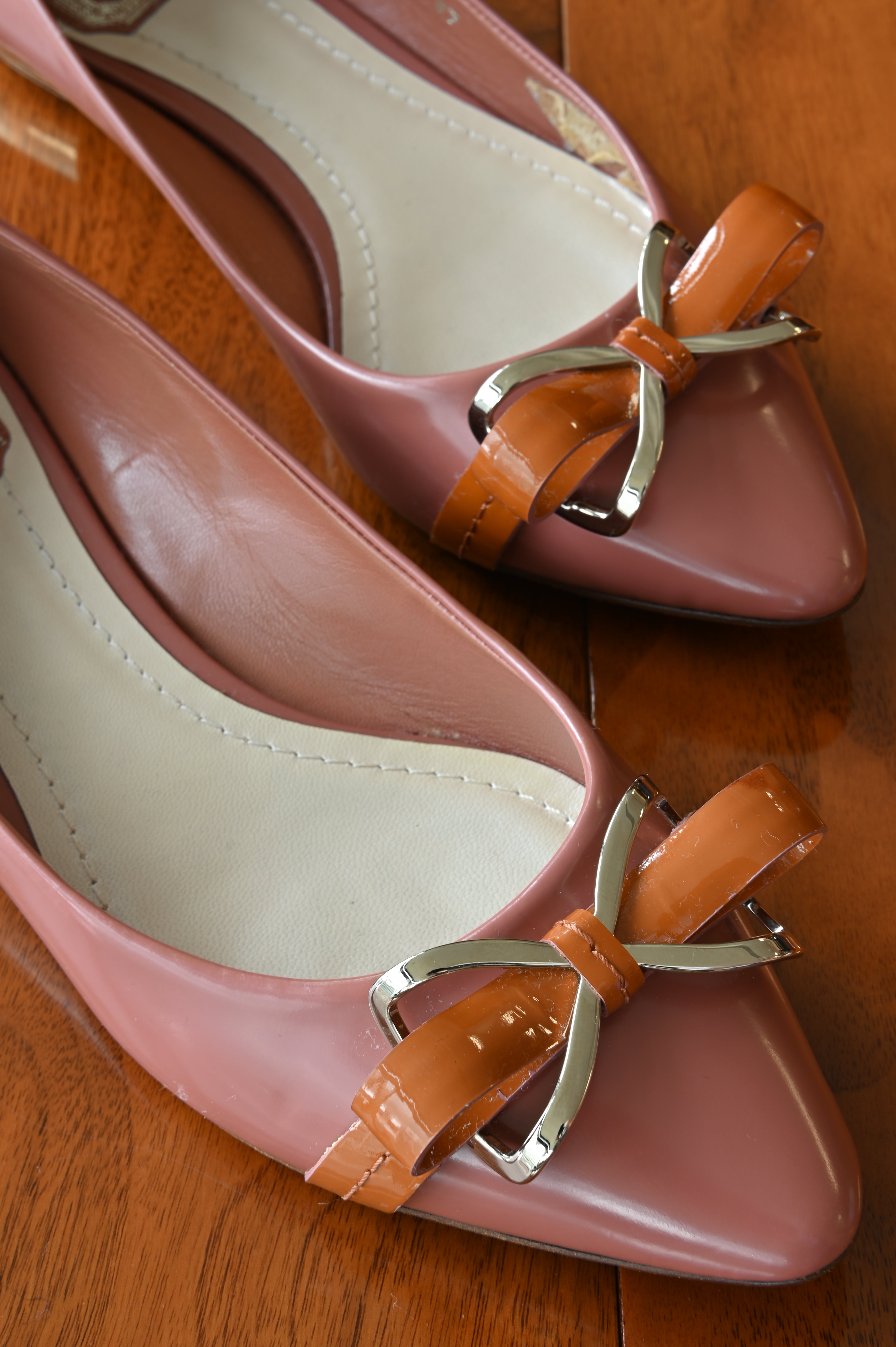 Authentic Christian Dior Dusty Rose Patent Ballet Flats viewed from above, highlighting the patent leather finish, bow detail and pointed toe design.
