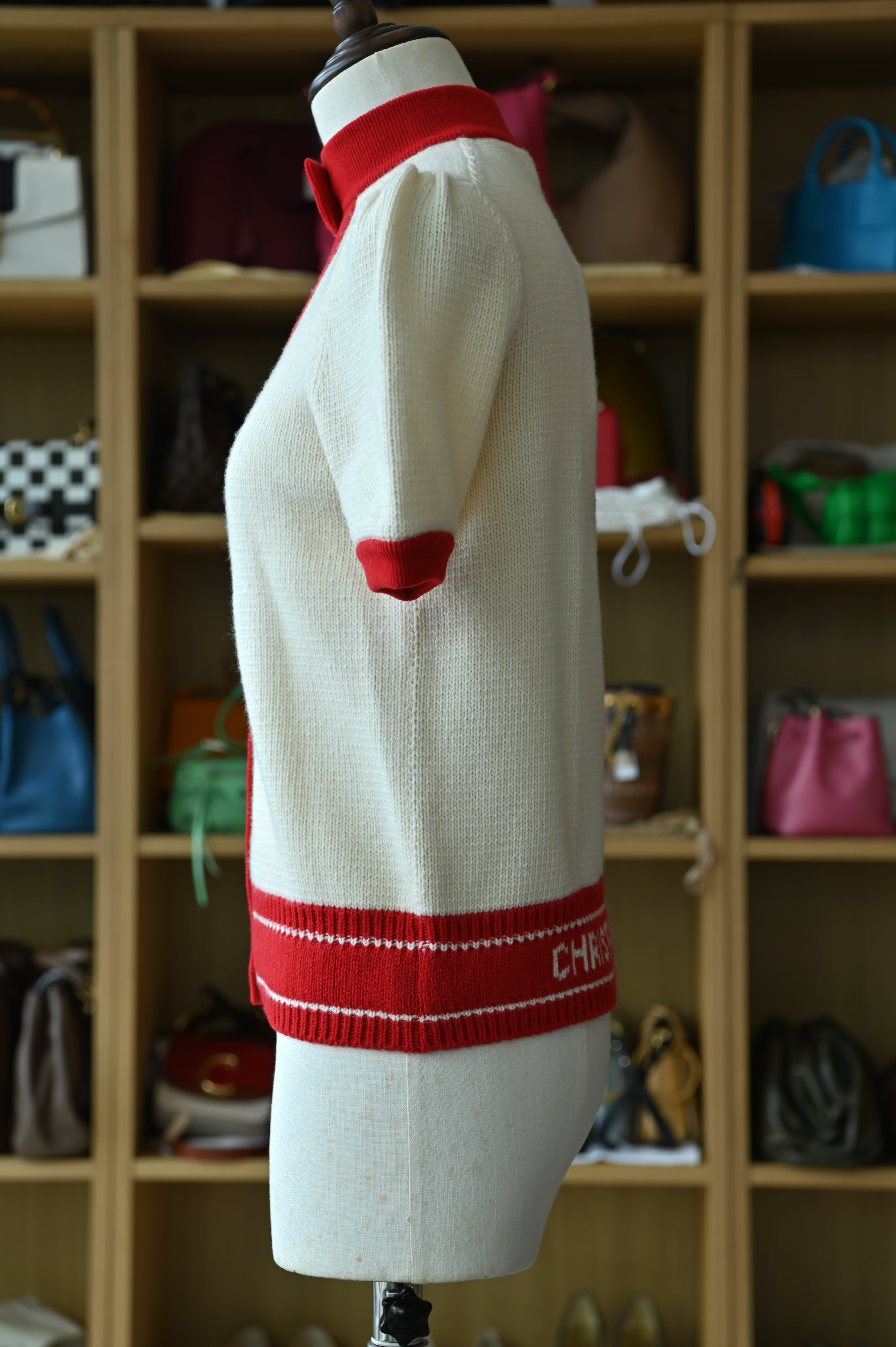 Authentic Christian Dior White & Red Knit Cardigan showing the left side profile with premium knit construction and contrast trim.
