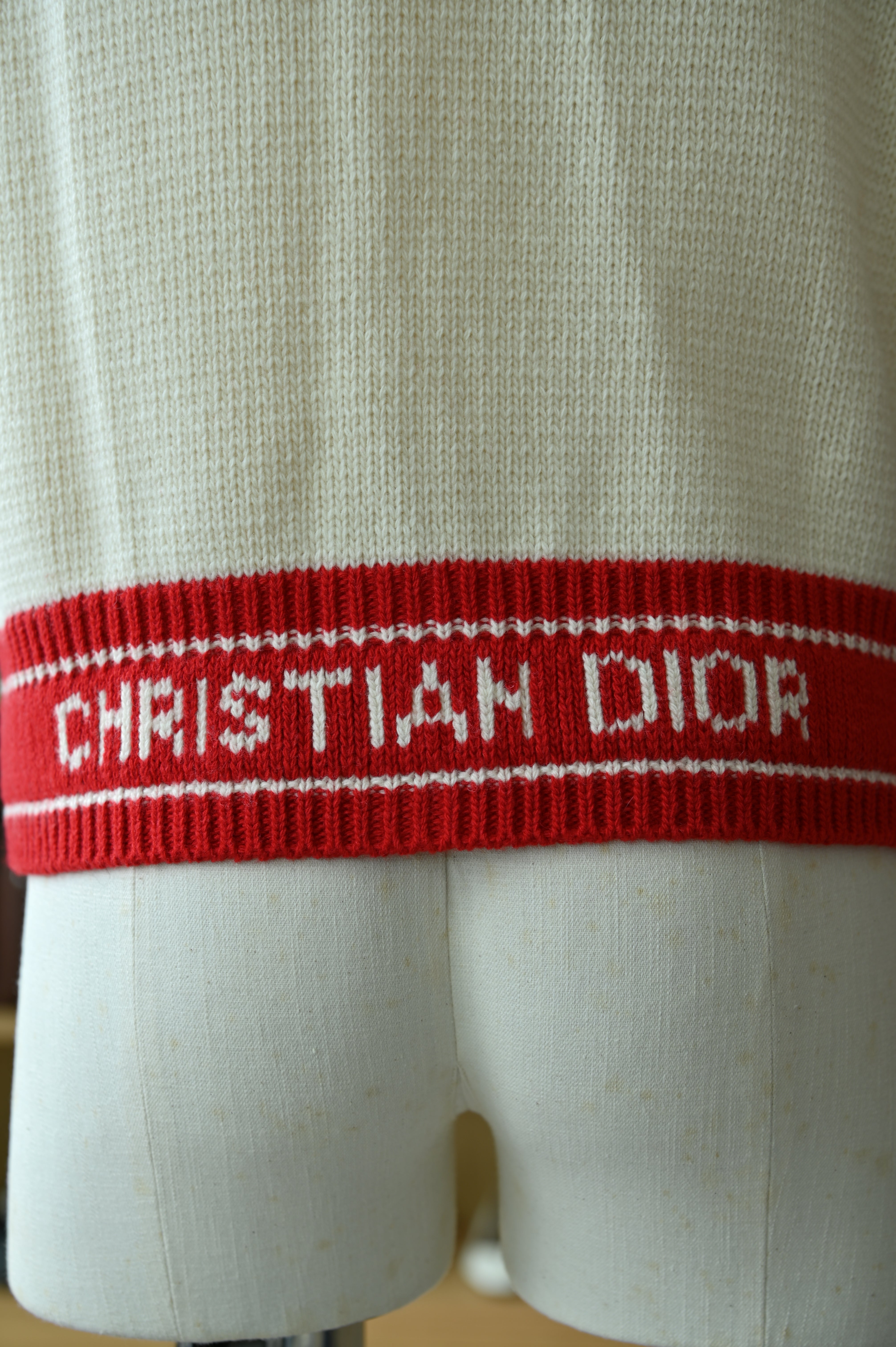 Close-up of the authentic Christian Dior White & Red Knit Cardigan highlighting the Christian Dior logo detail and premium knit texture.