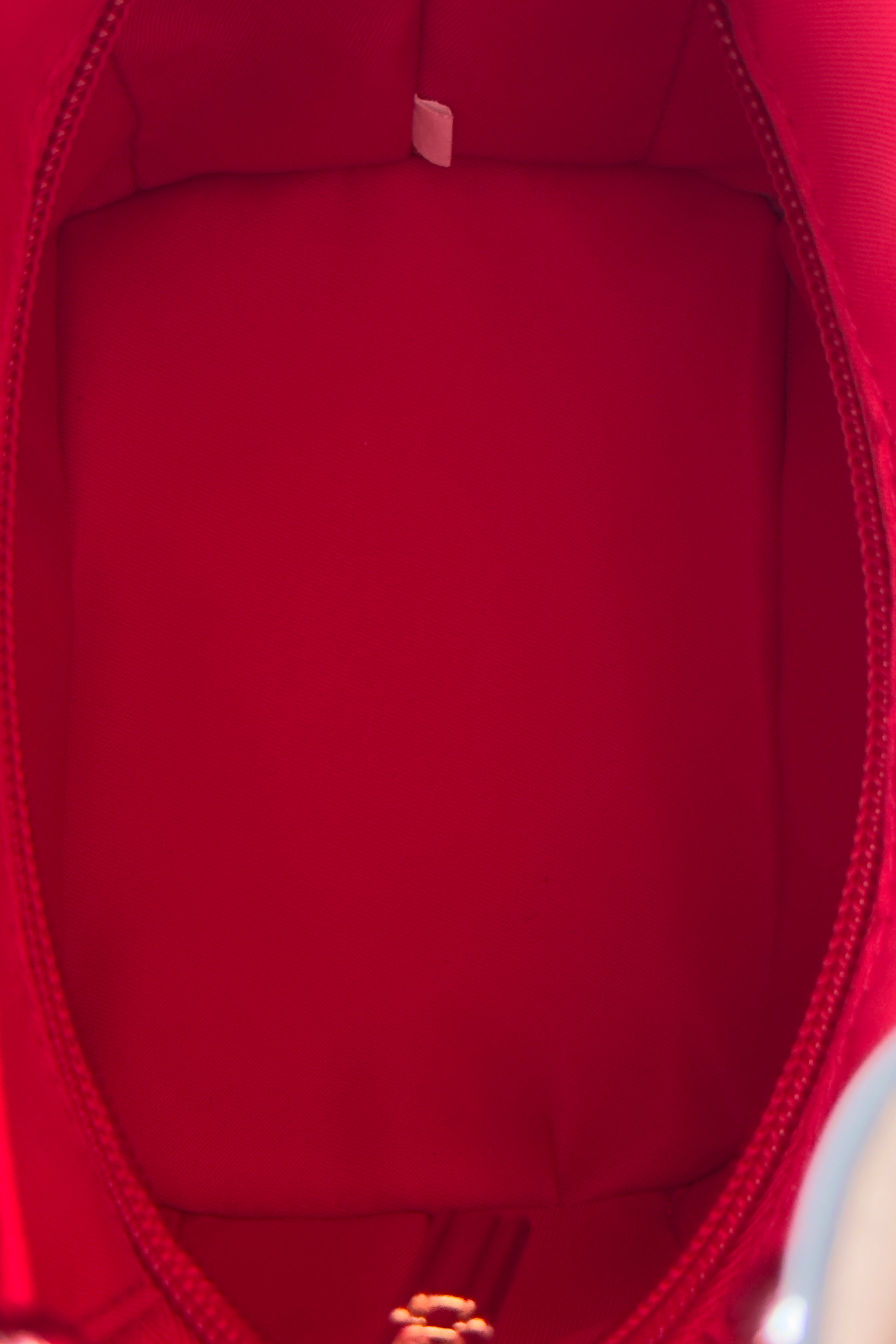 Authentic Christian Louboutin By My Side Light Pink Bucket Bag showing its signature Christian Louboutin red interior.
