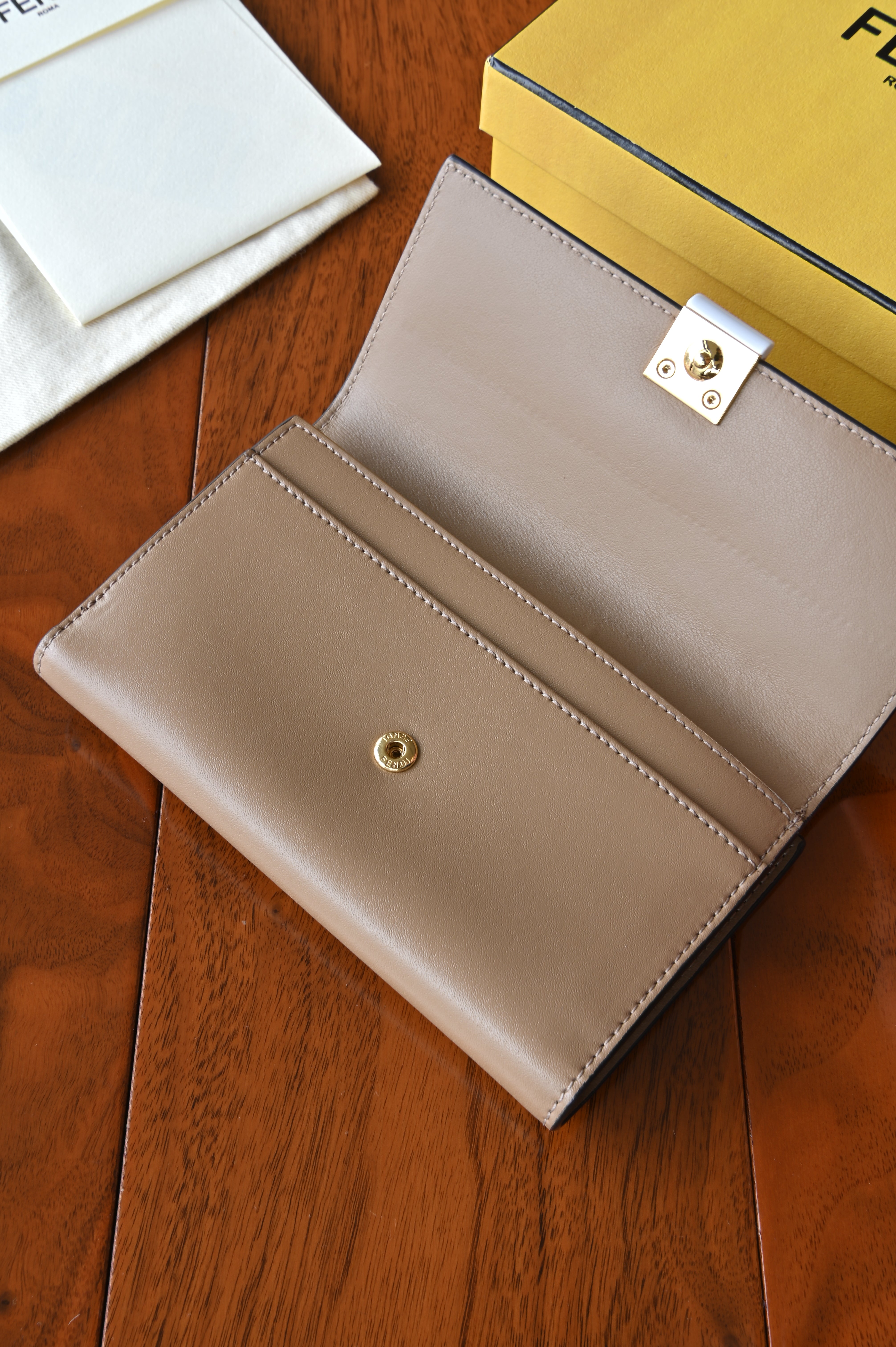 Interior view of the authentic Fendi beige leather continental wallet showing multiple compartments and card slots.