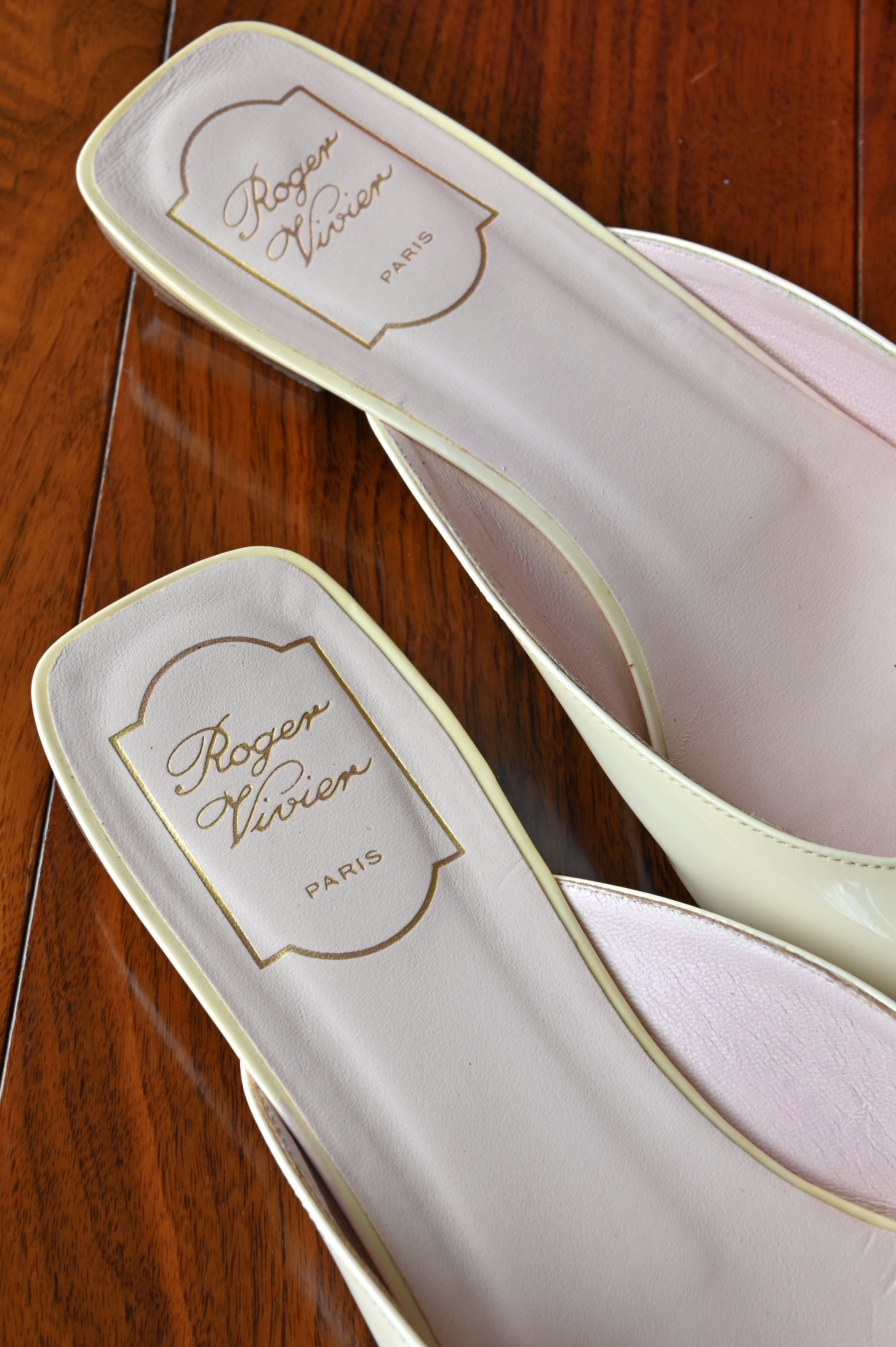 Close-up of the Roger Vivier Paris branding on the blush pink leather footbeds, highlighting the luxurious Italian craftsmanship.