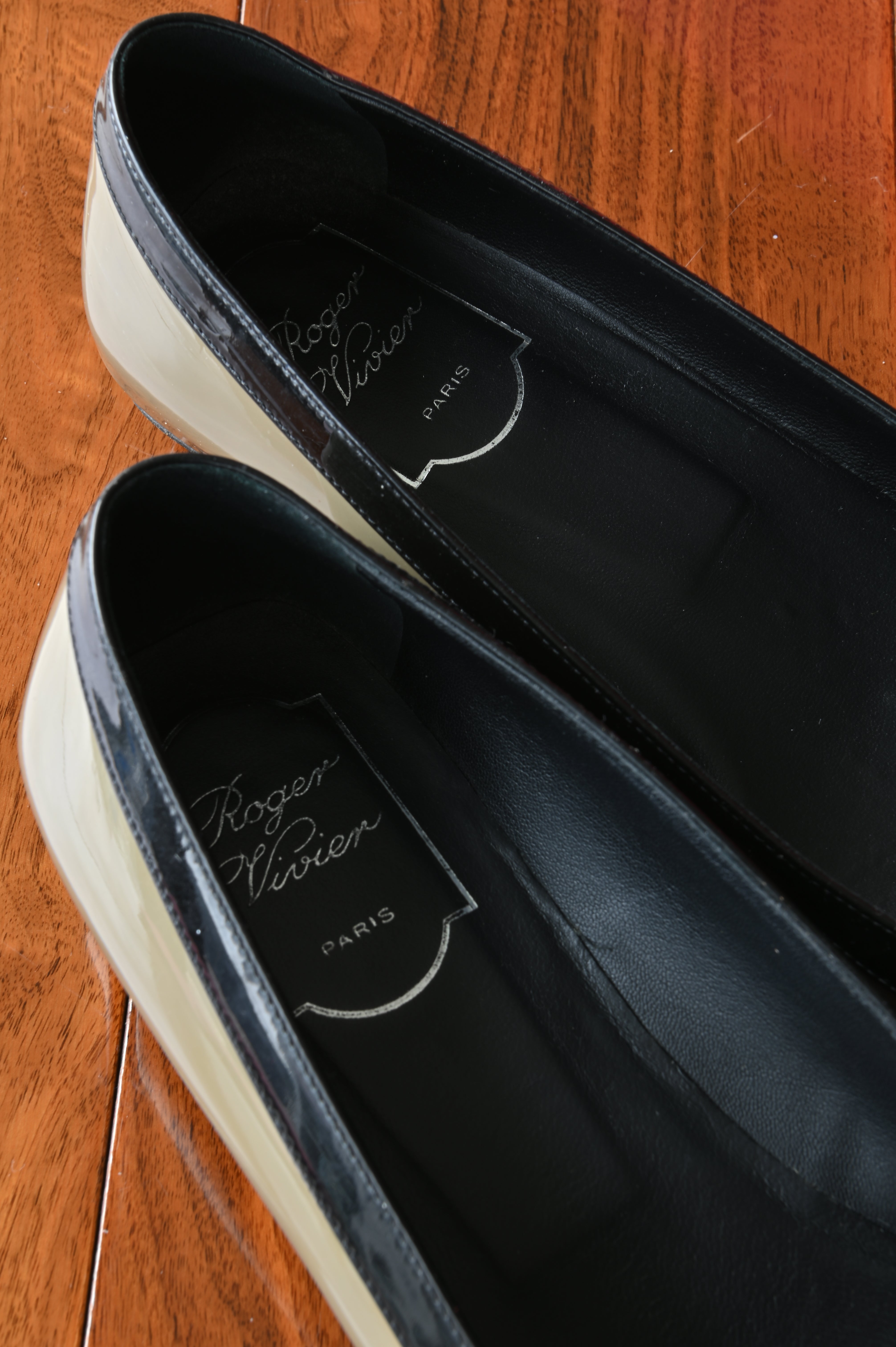 Close-up of the Roger Vivier Paris branding and black leather interior, highlighting the luxurious craftsmanship and clean condition.