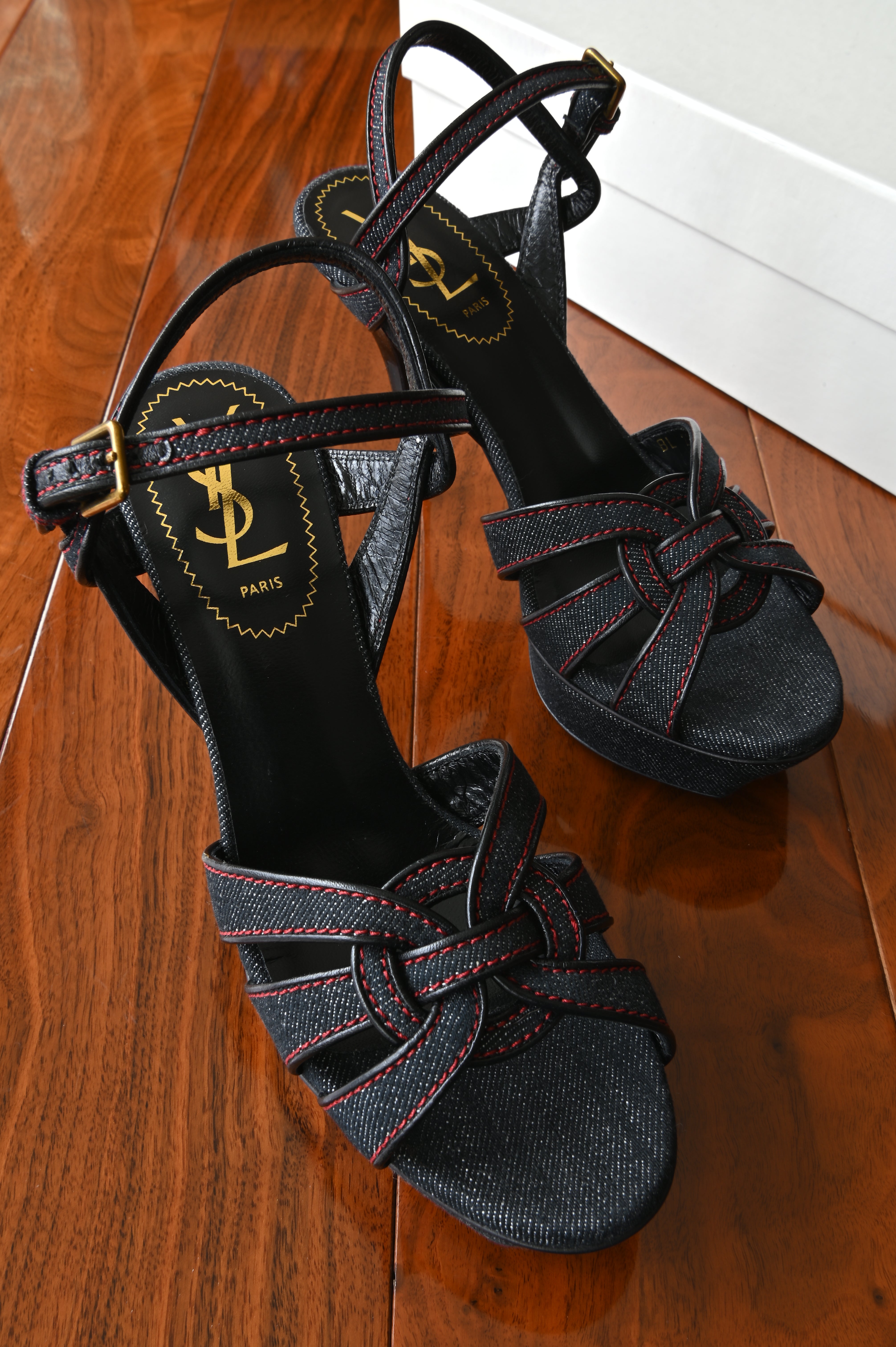 Authentic Saint Laurent Tribute Platform Sandals in black denim with red contrast stitching, front angled view showcasing the signature interwoven Tribute straps