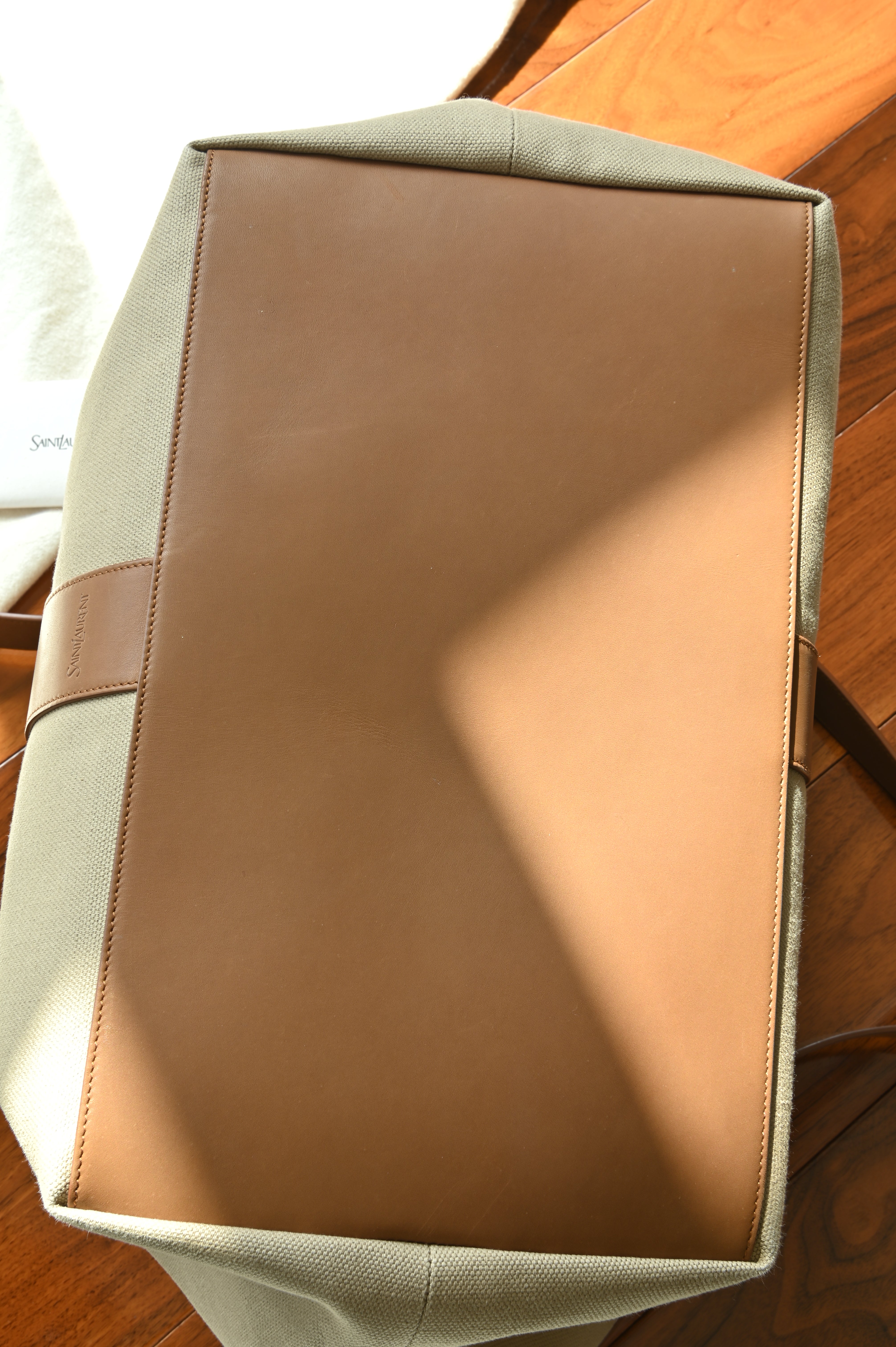 Authentic Saint Laurent Y Canvas Shopping Tote Bag showing the structured canvas and leather base with clean stitching and durable construction.