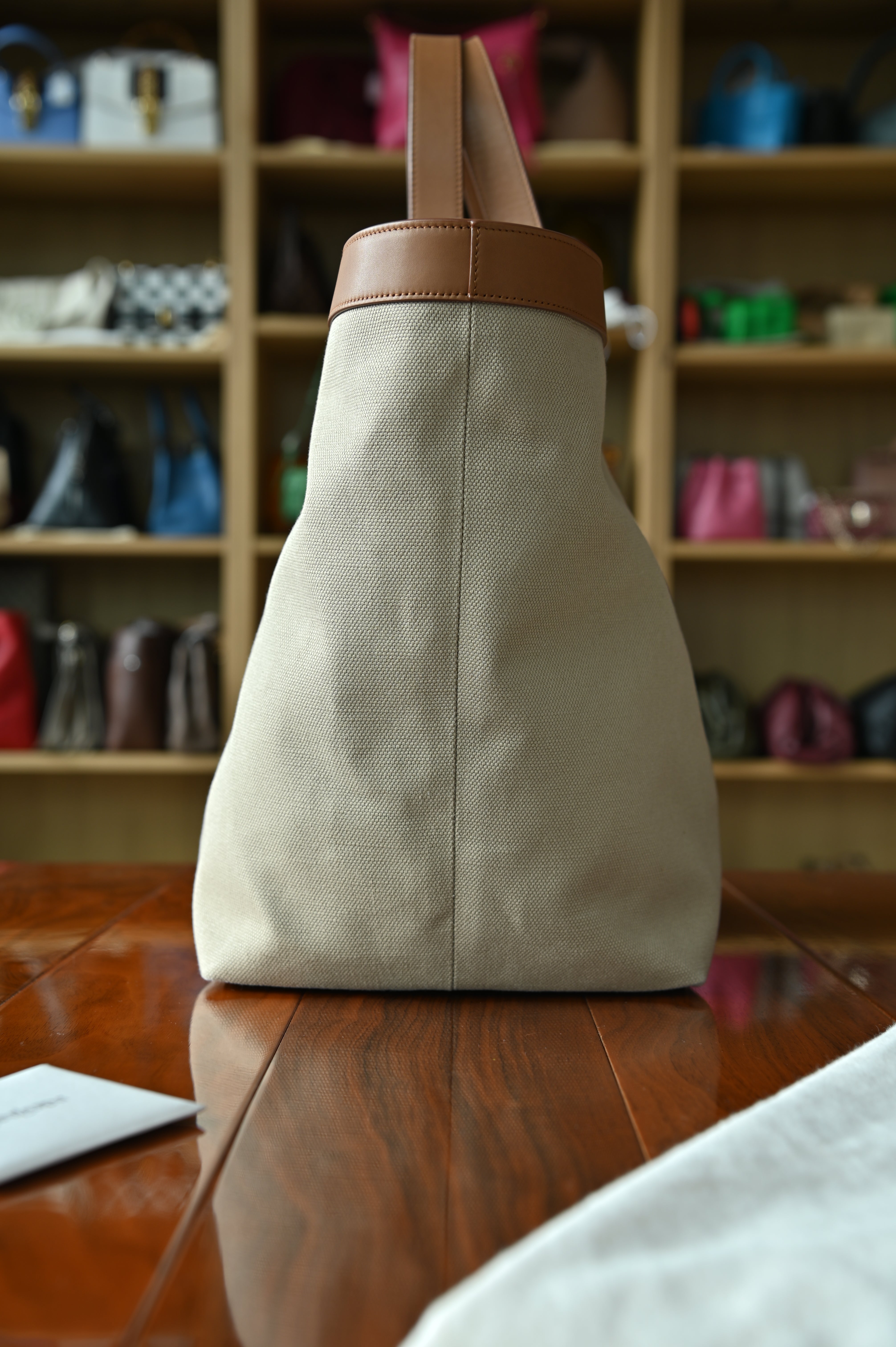 Authentic Saint Laurent Y Canvas Shopping Tote Bag showing the right side profile with smooth tan leather shoulder straps and structured canvas body.