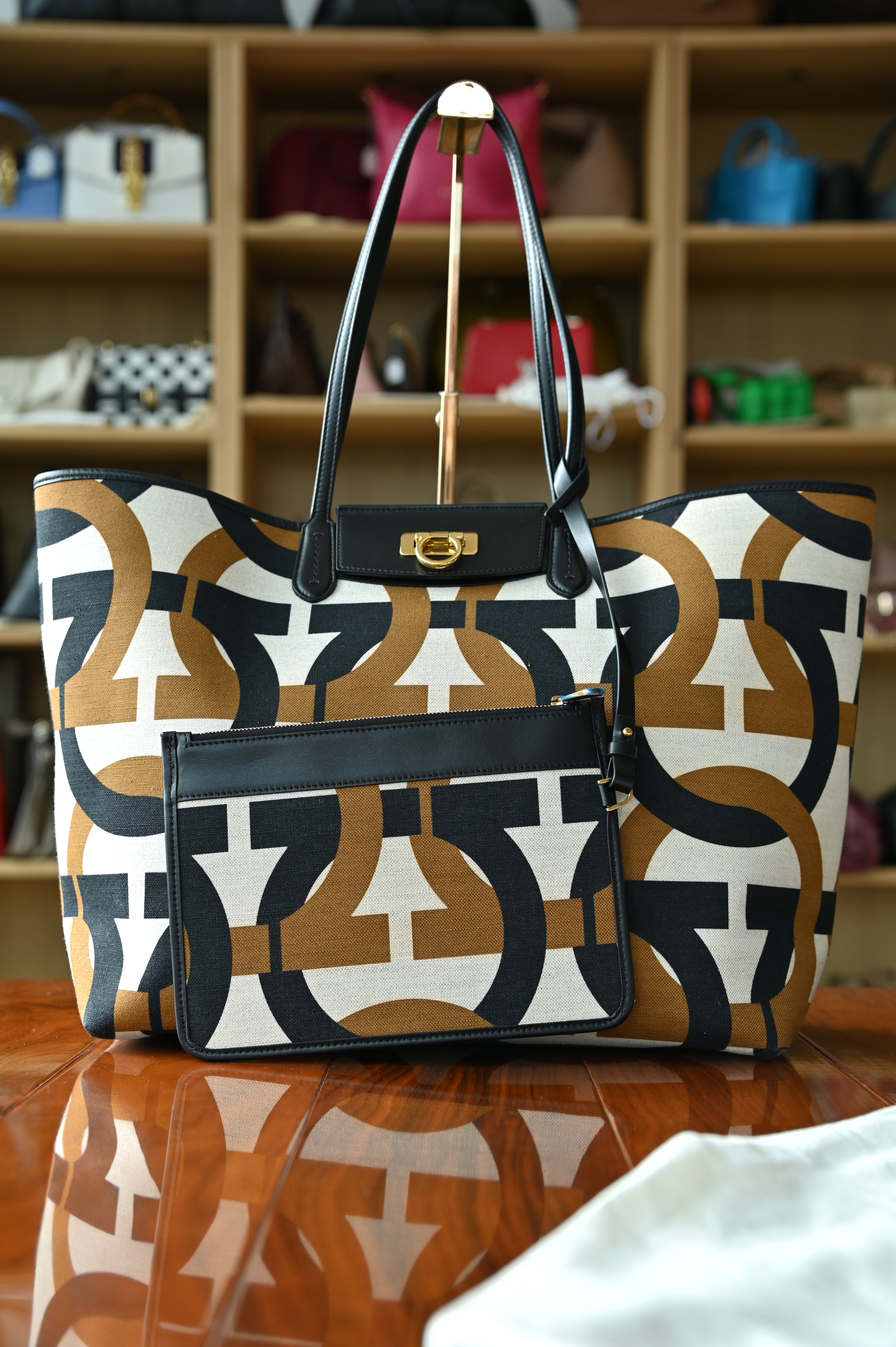 Authentic Salvatore Ferragamo detachable monogram canvas pouch showing the reverse side with matching canvas pattern and black leather trim.