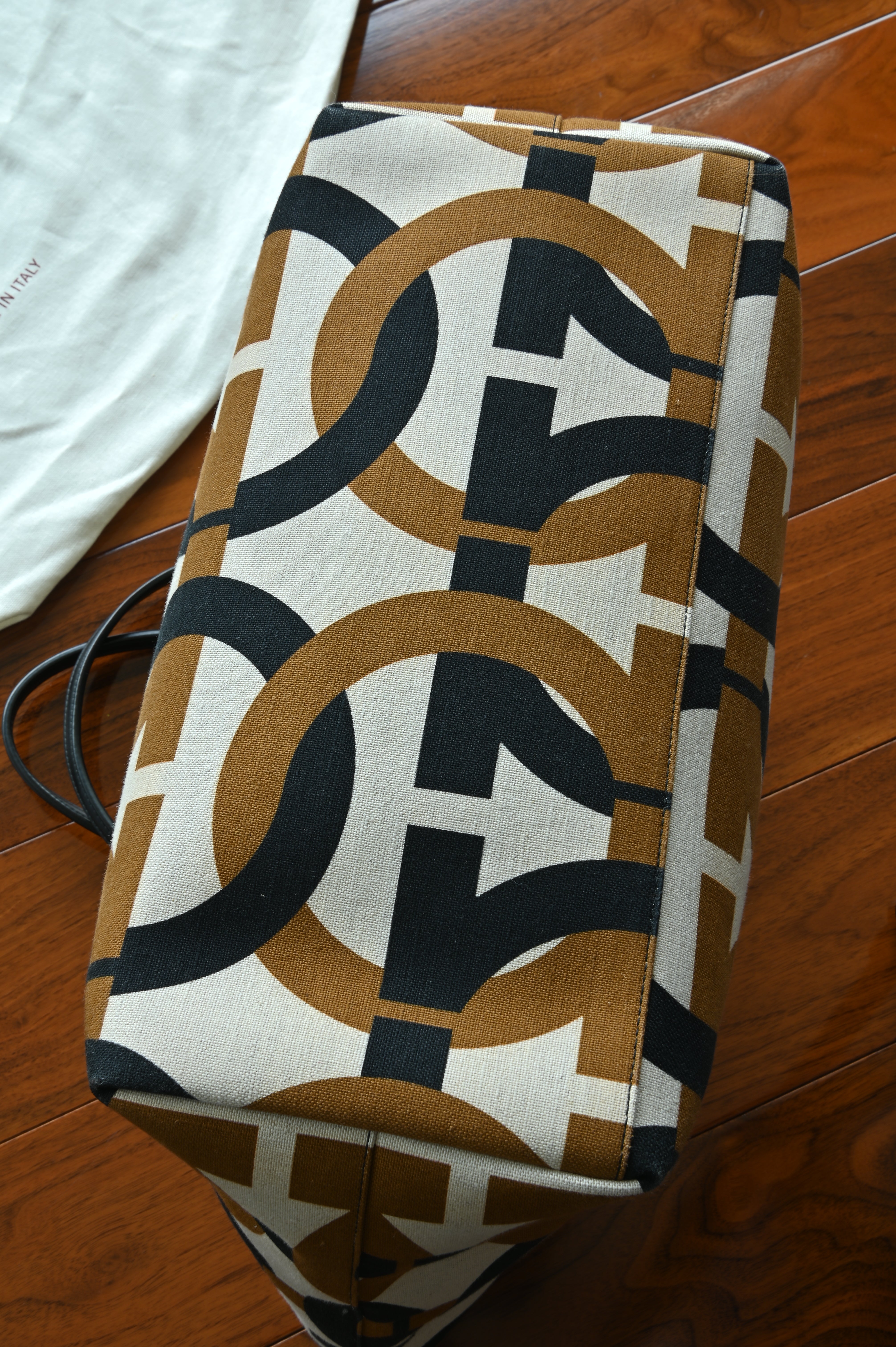 Authentic Salvatore Ferragamo Monogram Canvas Tote Bag showing the base with the signature Gancini monogram canvas pattern.