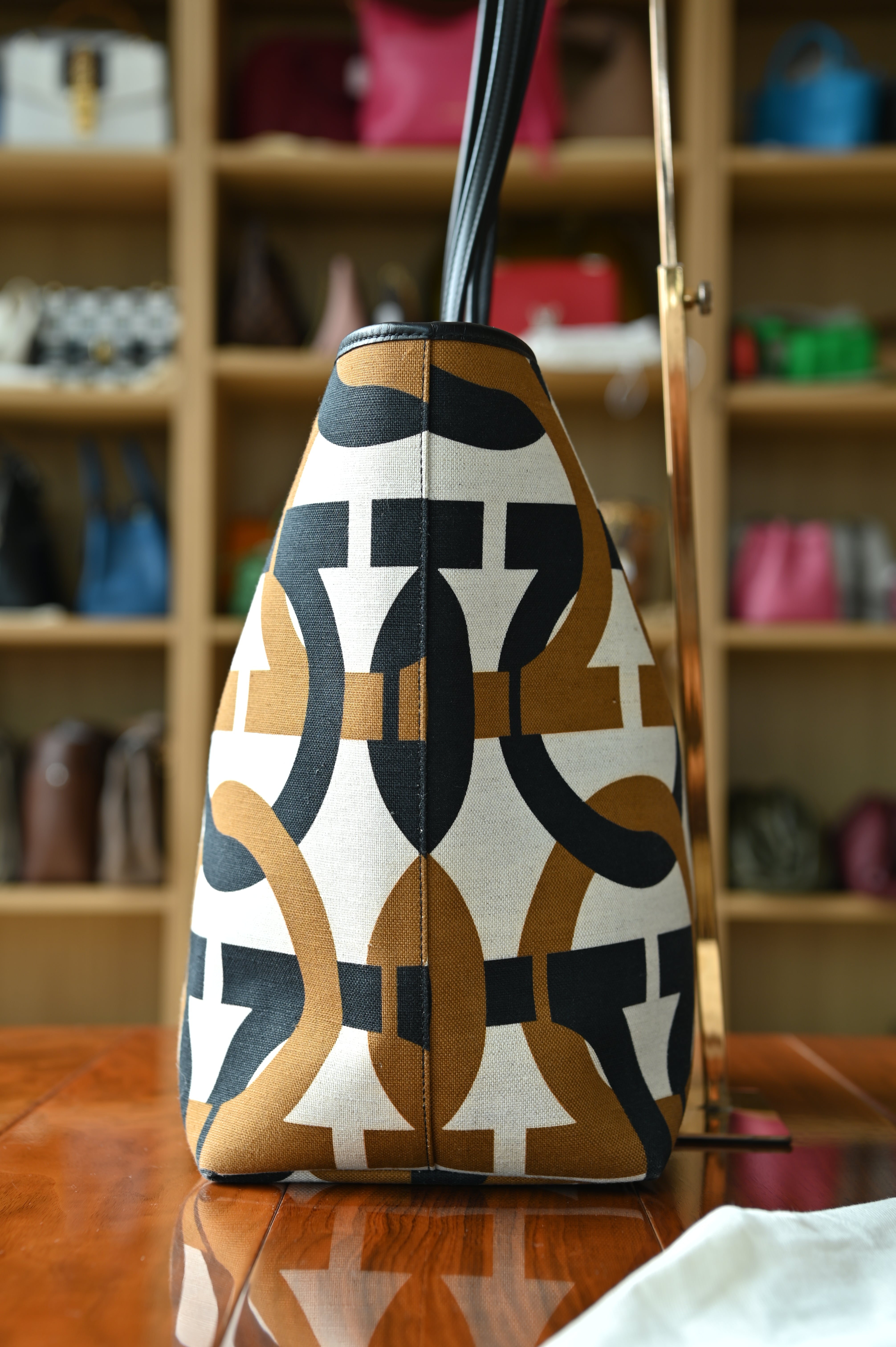 Authentic Salvatore Ferragamo Monogram Canvas Tote Bag showing the right side profile with signature monogram canvas and leather trim.