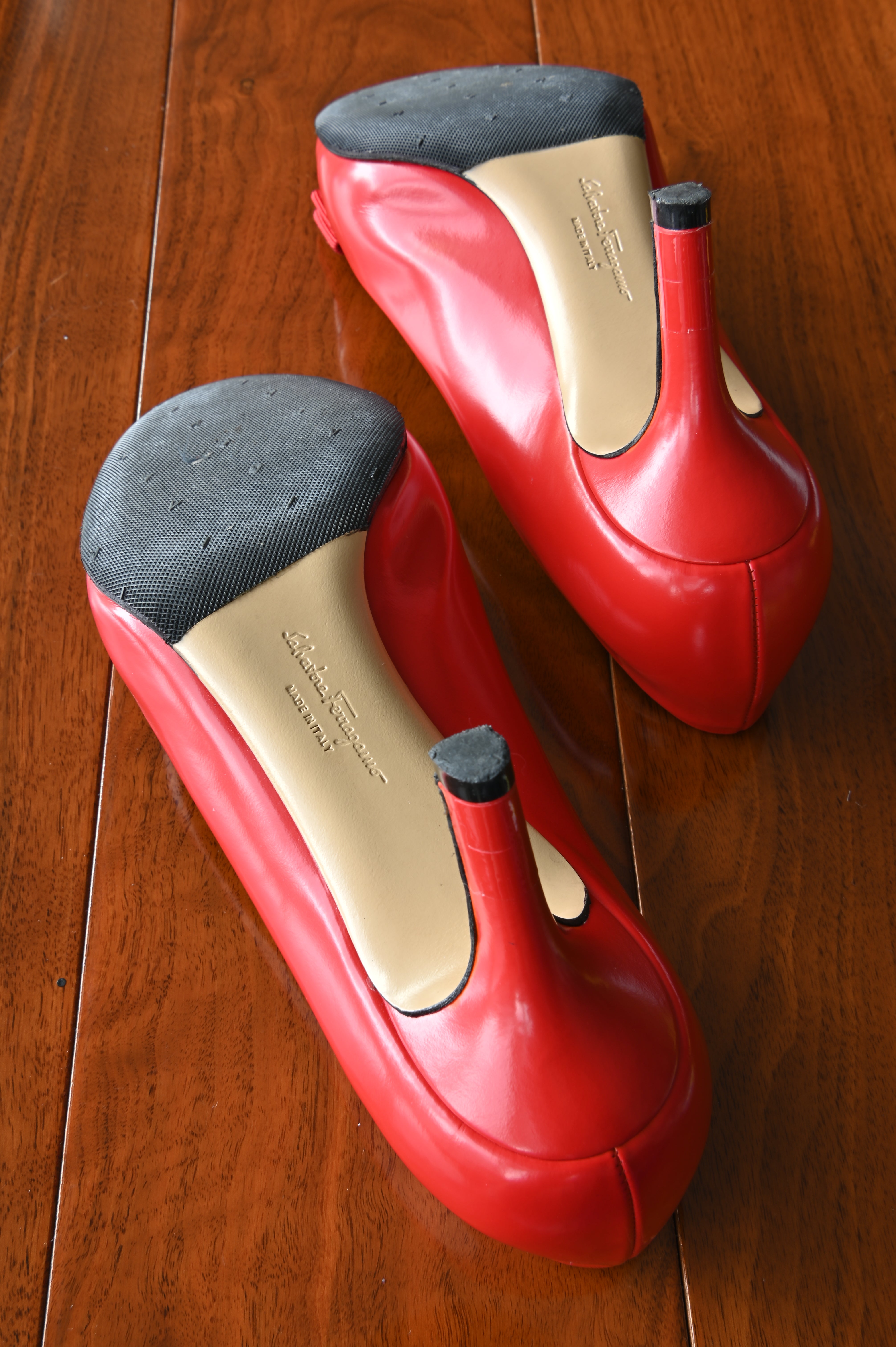 Bottom view of authentic Salvatore Ferragamo Vara pumps showing lightly worn outsoles in like new condition
