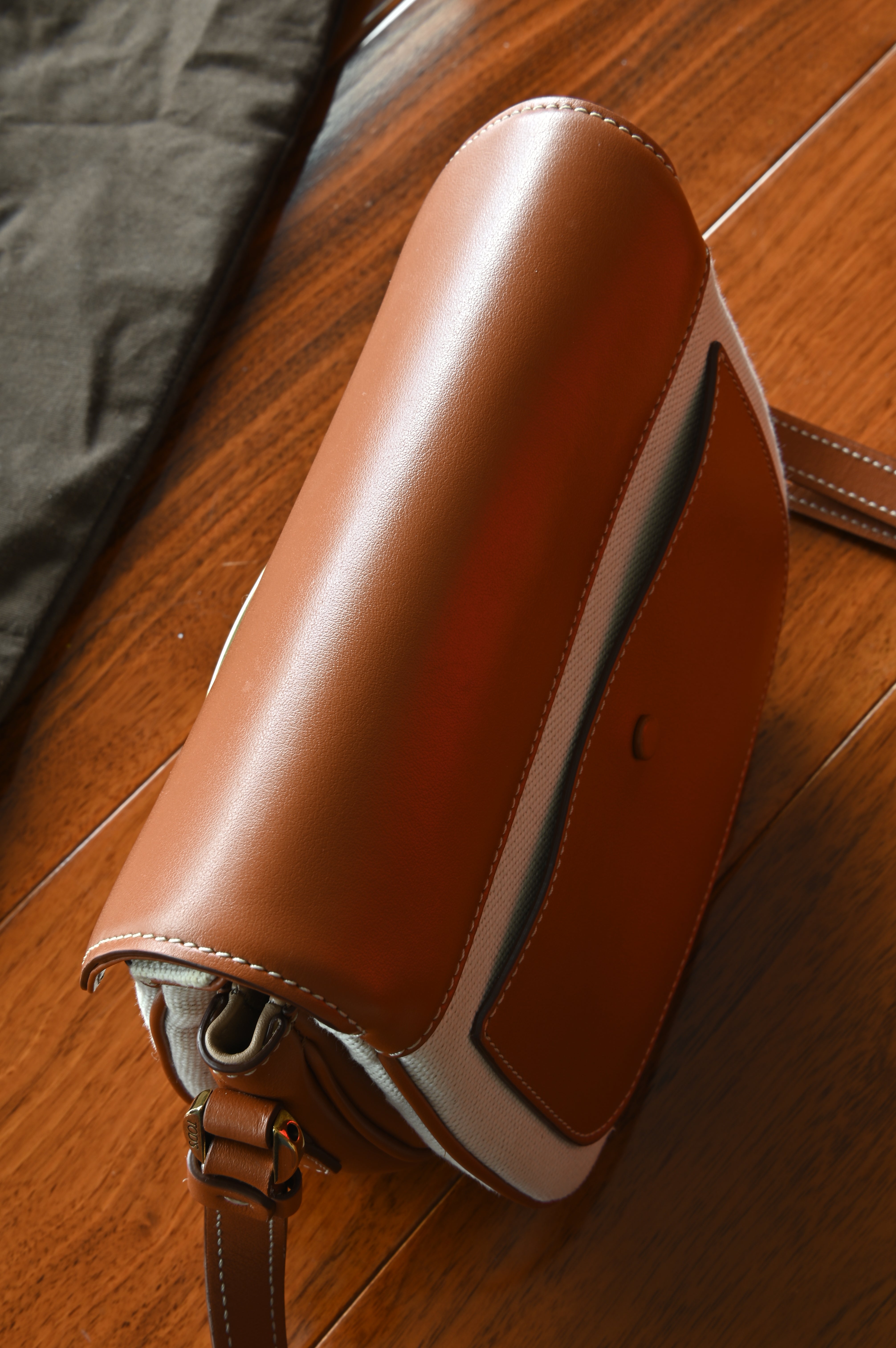 Authentic Tod’s Brown & Beige Canvas Logo Crossbody Bag showing the leather base with clean stitching and structured construction