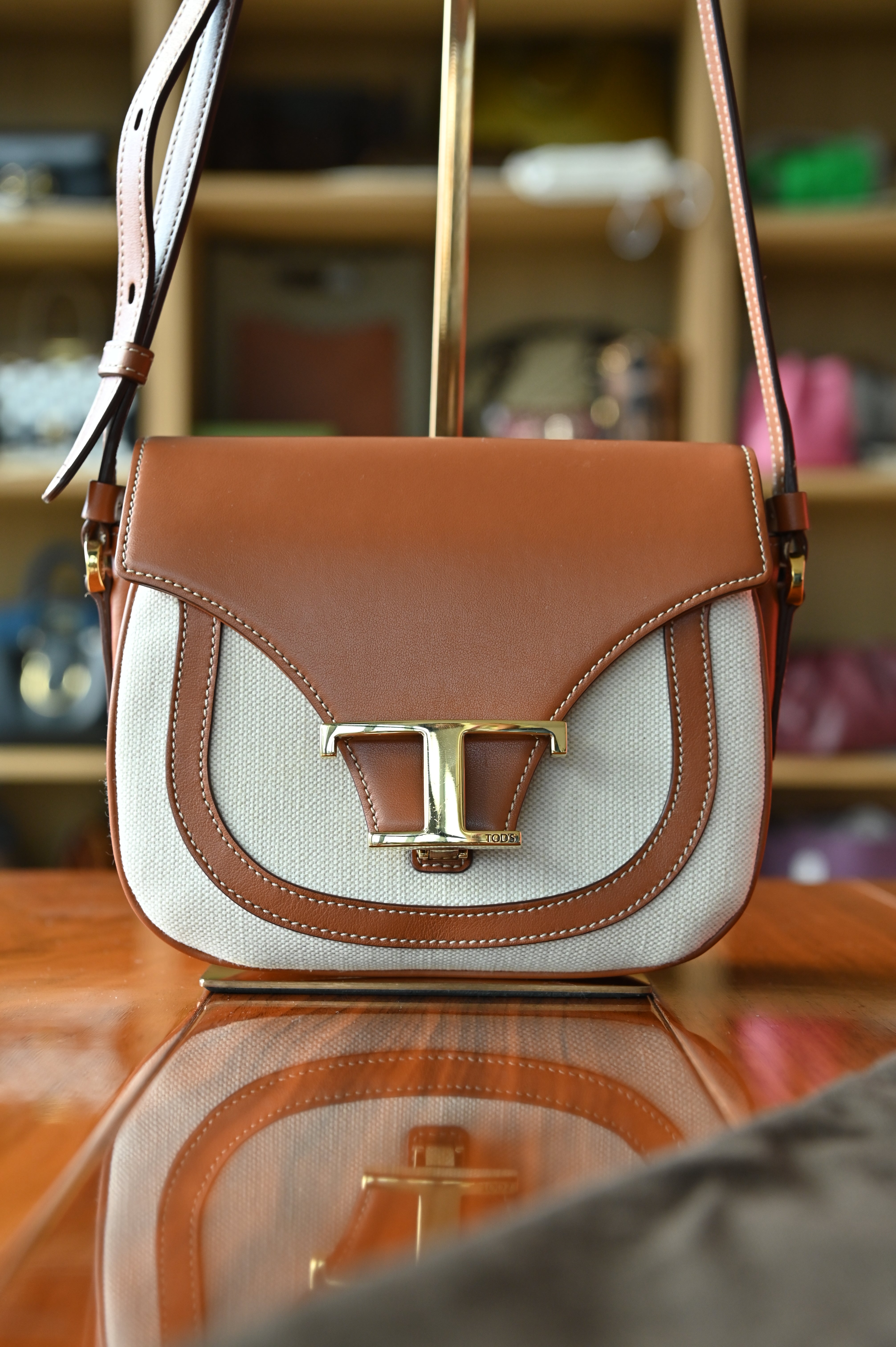 Authentic Tod’s Brown & Beige Canvas Logo Crossbody Bag featuring signature logo hardware, canvas body and leather trim, front view.